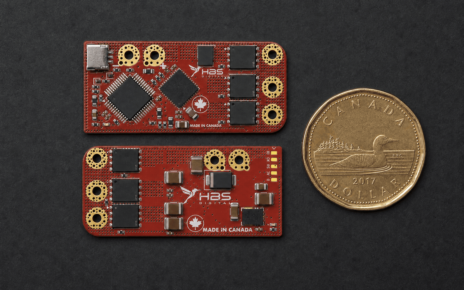 Front and back views of the HBS ESC beside a Canadian one-dollar coin for scale