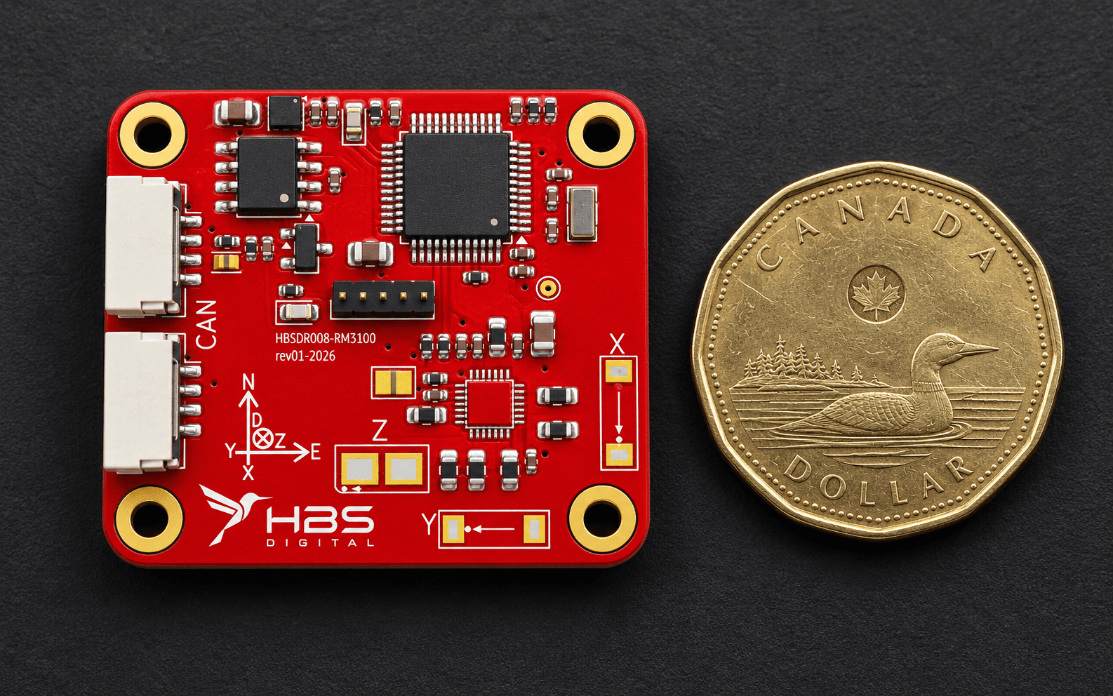HBS RM3100 DroneCAN magnetometer board beside a Canadian one-dollar coin for scale